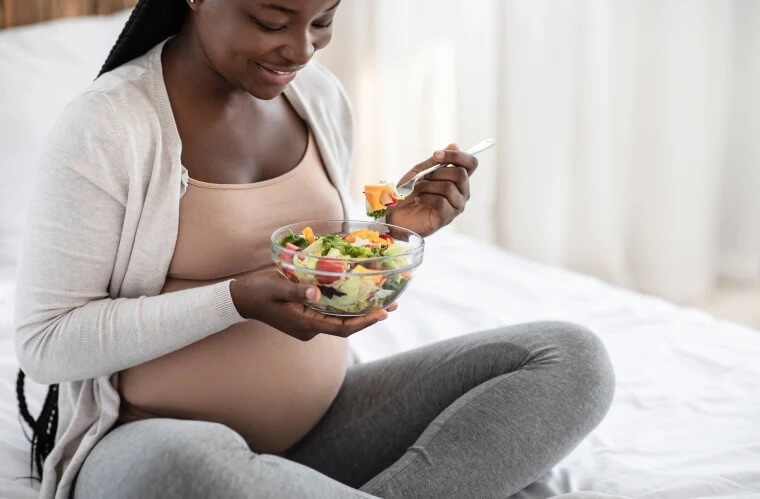 What To Eat While Pregnant. Pregnant Person Eating.